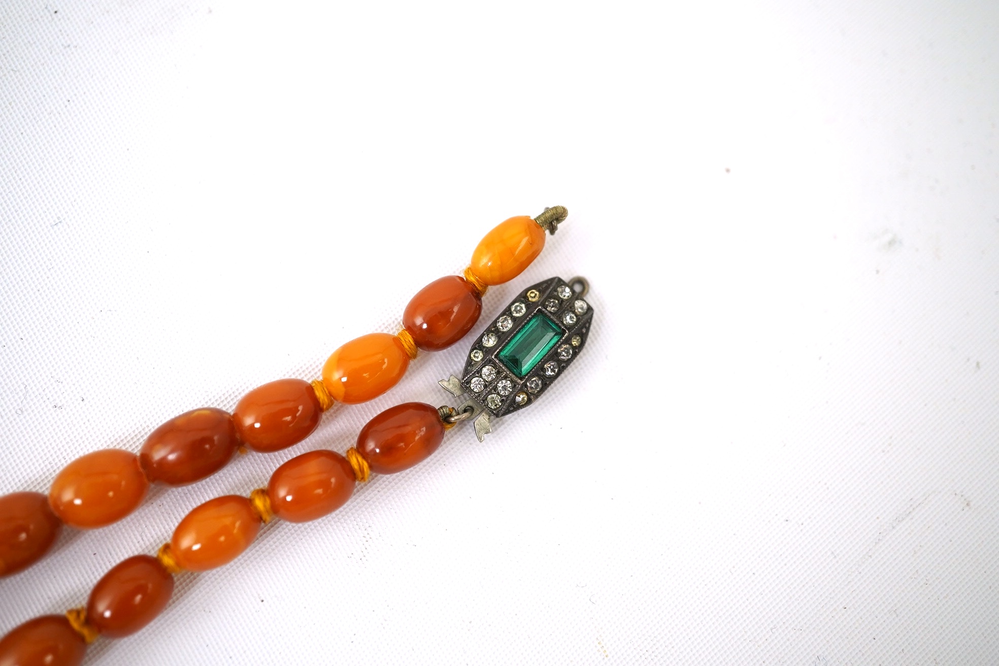 A single strand graduated oval amber bead necklace